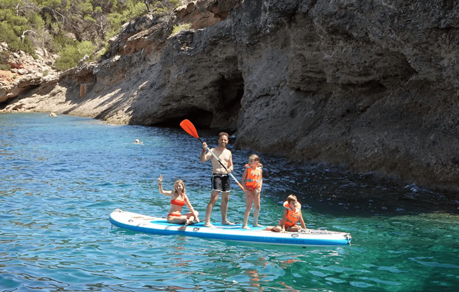 Family enjoying paddleboarding together
